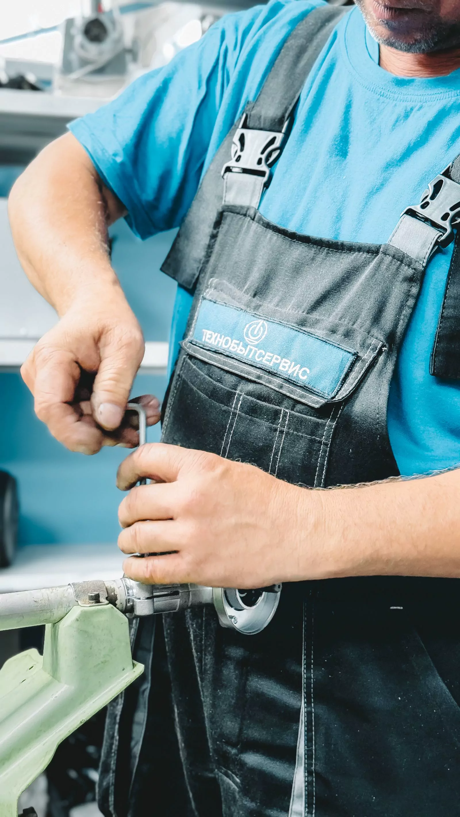 Plumber working with a wrench on field equipment